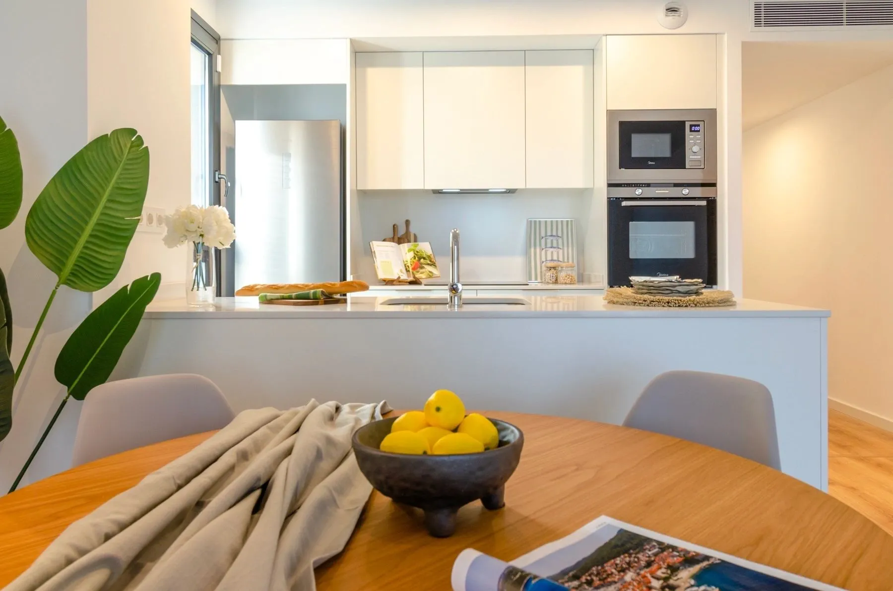 Kitchen and dining room of the Badalona I project, in Badalona, after the interior design project