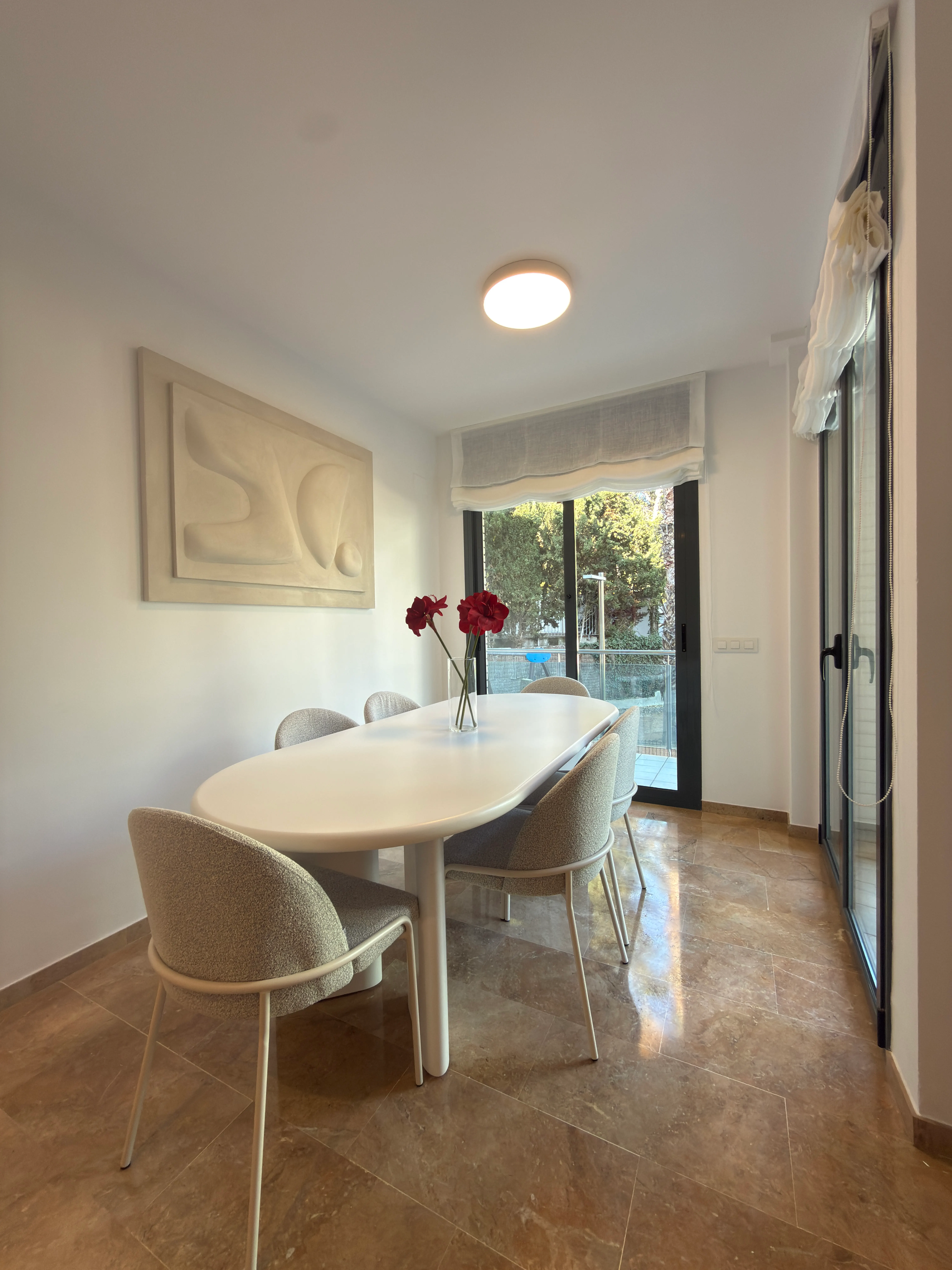 Dining room of the Fenals project, in Lloret de Mar, after the interior design project